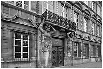 Facade with sculptures supporting a balcony. Aix-en-Provence, France ( black and white)