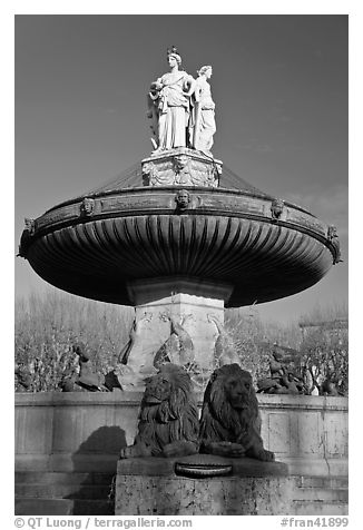 Monumental fountain with three statues representing art, justice and agriculture. Aix-en-Provence, France (black and white)