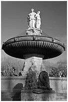 Monumental fountain with three statues representing art, justice and agriculture. Aix-en-Provence, France ( black and white)