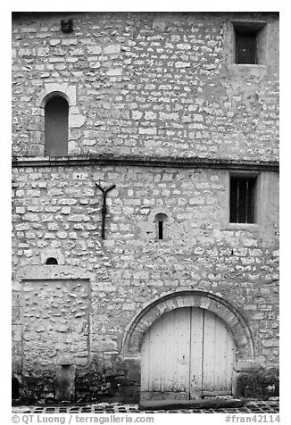 Facade detail of medieval house with small windows, Provins. France (black and white)