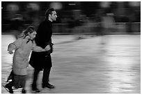 Man skating with daughter by night. Paris, France (black and white)