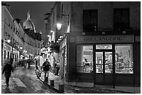 Bakery, street and dome of Sacre-Coeur at twilight, Montmartre. Paris, France (black and white)