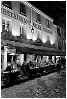 Restaurant with outdoor sitting by night, Montmartre. Paris, France ( black and white)