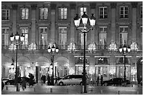 Lights and palace-like classical fronts of Hotel Ritz by Jules Hardouin-Mansart. Paris, France ( black and white)