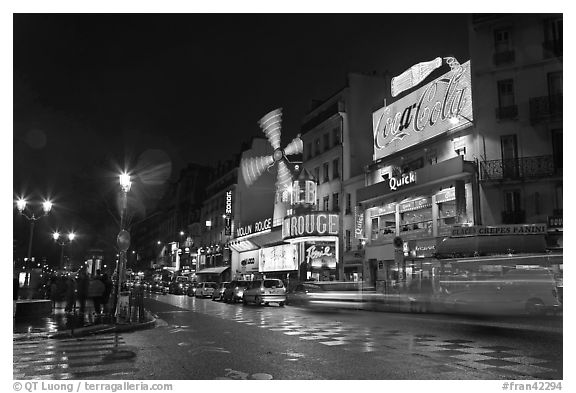 Boulevard by night with Moulin Rouge. Paris, France (black and white)