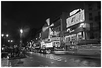 Boulevard by night with Moulin Rouge. Paris, France ( black and white)