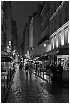 Pedestrian street with restaurants at night. Quartier Latin, Paris, France ( black and white)