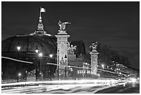 Petit Palais and trafic across Alexandre III bridge by night. Paris, France ( black and white)