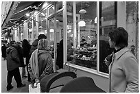 Customers wait in line in front of a popular bakery. Paris, France ( black and white)