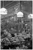 Woman selling pastries and bread in bakery. Paris, France ( black and white)