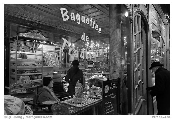 Elderly man entering bakery with people inside. Paris, France