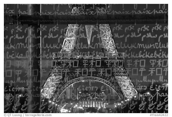 Lit Eiffel Tower seen through the words Peace written in many languages. Paris, France (black and white)