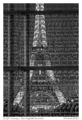 Illuminated Eiffel Tower seen through peace memorial. Paris, France (black and white)
