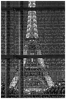 Illuminated Eiffel Tower seen through peace memorial. Paris, France (black and white)