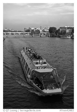 Bateau-mouche (tour boat) on Seine River. Paris, France (black and white)