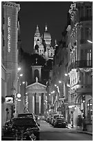 Street, Notre-Dame-de-Lorette, and Sacre Coeur at night. Paris, France (black and white)
