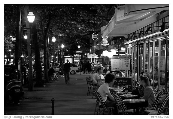 Outdoor cafe terrace on the Grands Boulevards at night. Paris, France