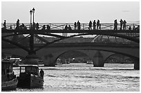 Seine river and people silhouettes on Pont des Arts. Paris, France ( black and white)