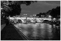 Quay, Seine River, and Pont-Neuf at night. Paris, France ( black and white)