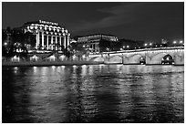 Pont Neuf and Samaritaine reflected in Seine River at night. Paris, France ( black and white)