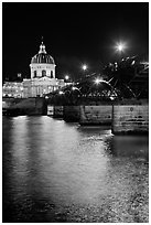 Institut de France and Pont des Arts reflected in Seine river at night. Paris, France ( black and white)