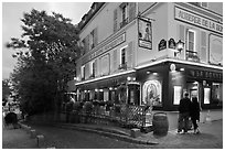 Couple looking at menu outside restaurant, Montmartre. Paris, France ( black and white)