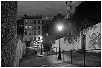 Hillside stairs of butte Montmartre and street lights at sunset. Paris, France ( black and white)