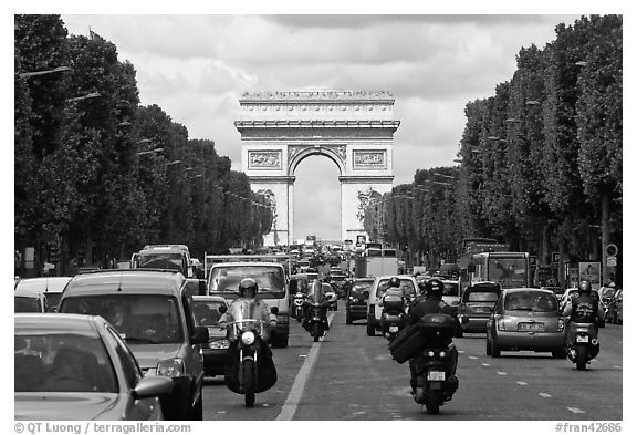 Car and motorcycle traffic and Arc de Triomphe, Champs-Elysees. Paris, France