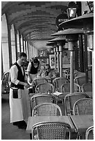 Waiters and customer, place des Vosges arcades. Paris, France ( black and white)