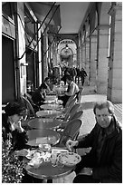 Couple eating at an outdoor table in the Palais Royal arcades. Paris, France ( black and white)
