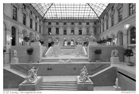 Louvre Museum room with sculptures and skylight. Paris, France (black and white)