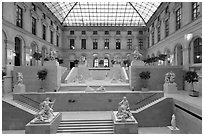 Louvre Museum room with sculptures and skylight. Paris, France ( black and white)