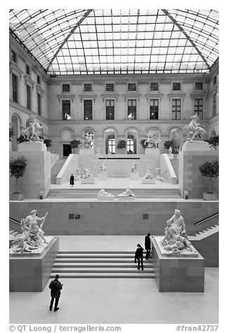 Tourists and exhibit inside Louvre museum. Paris, France (black and white)