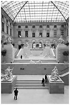 Tourists and exhibit inside Louvre museum. Paris, France ( black and white)