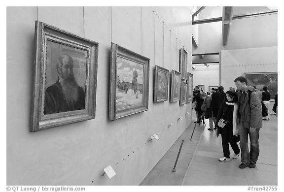 Couple looking at impressionists paintings, Orsay Museum. Paris, France