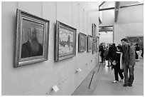 Couple looking at impressionists paintings, Orsay Museum. Paris, France (black and white)