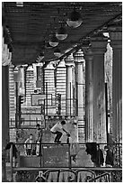 Youngsters skateboarding below metro bridge. Paris, France (black and white)