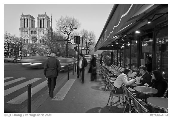 Cafe, street, and Notre Dame at dusk. Quartier Latin, Paris, France