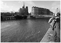 Fishermen on ile Saint Louis, with ile de la Cite in the background. Paris, France ( black and white)