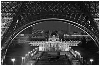 Ecole Militaire (Military Academy) seen through Eiffel Tower at night. Paris, France (black and white)