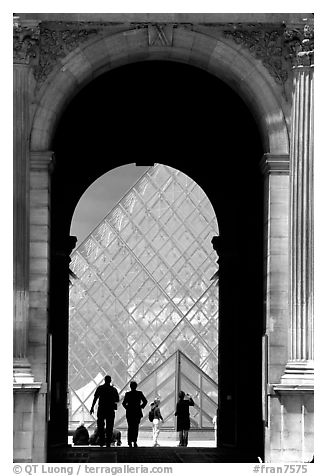 Pyramid seen through one of the Louvre's Gates. Paris, France (black and white)