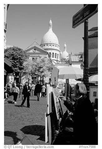 Painter on Place du Tertre, with the Sacre Coeur in the background, Montmartre. Paris, France