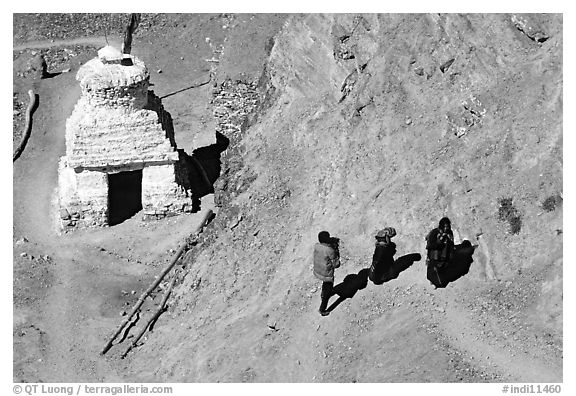 People ascending a trail past a chorten below Phuktal,  Zanskar, Jammu and Kashmir. India (black and white)