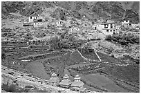 Chortens, cultivated terraces,  and village, Zanskar, Jammu and Kashmir. India ( black and white)