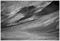 Barren hills with figures walking towards Karsha monastery, Zanskar, Jammu and Kashmir. India (black and white)
