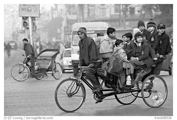 Cycle-rickshaw with a load of ten schoolchildren. New Delhi, India
