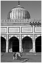 Group of people walking out of prayer hall. New Delhi, India ( black and white)