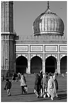 Group of people, courtyard, prayer hall, and dome, Jama Masjid. New Delhi, India ( black and white)