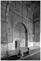 Muslim men praying, prayer hall, Jama Masjid. New Delhi, India ( black and white)