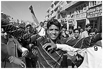 Young men celebrating during wedding procession. Jodhpur, Rajasthan, India (black and white)